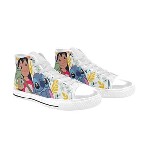 May include: White high-top sneakers featuring a colorful design with cartoon characters Lilo and Stitch. The shoes have a floral pattern and white laces. The sneakers are a fun and playful style.