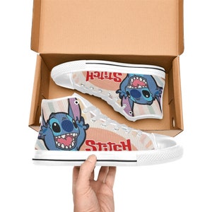 May include: White high-top canvas shoes with a colorful cartoon image of Stitch from Lilo & Stitch. The shoes have the word "Stitch" written in red on the side.