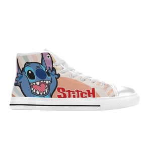 May include: White high-top canvas shoes with a colorful background featuring Stitch from Lilo & Stitch. The shoes have white laces and a black trim around the sole. The word "Stitch" is printed in red on the side of the shoe.