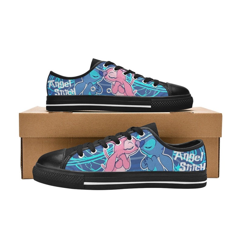 May include: A pair of black canvas shoes with a blue, pink, and white design featuring Stitch and Angel from Lilo & Stitch. The shoes have black laces and the text "Angel Stitch" on the side.
