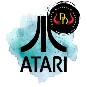 May include: A logo featuring the Atari symbol in black, with the word "ATARI" below it. The logo is set against a teal watercolor background. A circular logo with the text "OGDEN'S DEVILISH DESIGNS" surrounds a black circle with the letters "DD" and red devil horns.