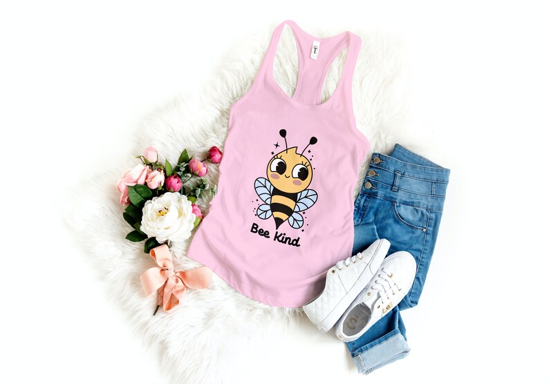 May include: A pink tank top with a cartoon bee graphic and the text "Bee Kind".