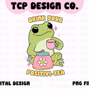Könnte beinhalten: Eine grüne Frosch-Karikatur, die eine rosa Teetasse und eine rosa Teekanne mit gelbem Blumendesign hält. Der Text "Drink Your Positivi-Tea" steht unter dem Frosch.