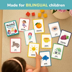 Child learning Russian using bilingual flashcards. Perfect for toddlers and preschoolers to explore first words visually through colorful illustrations. Educational Russian learning cards help kids connect objects with words naturally. Great teaching resource for parents, teachers, and homeschool learning activities.