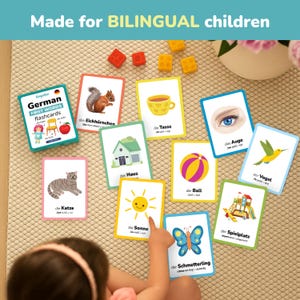 Child learning German using bilingual flashcards. Perfect for toddlers and preschoolers to explore first words visually through colorful illustrations. Educational German learning cards help kids connect objects with words naturally. Great teaching resource for parents, teachers, and homeschool learning activities.