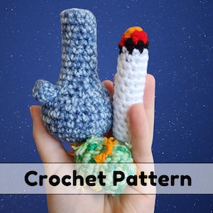 May include: Crochet pattern for a blue and white bong, a white cigarette with a red and black tip, and a green and orange crocheted ball.