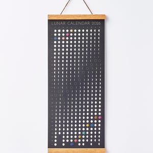 Moon Phase Lunar Calendar Print  hanging on wall with teak magnetic poster frame, modern minimalist home décor.