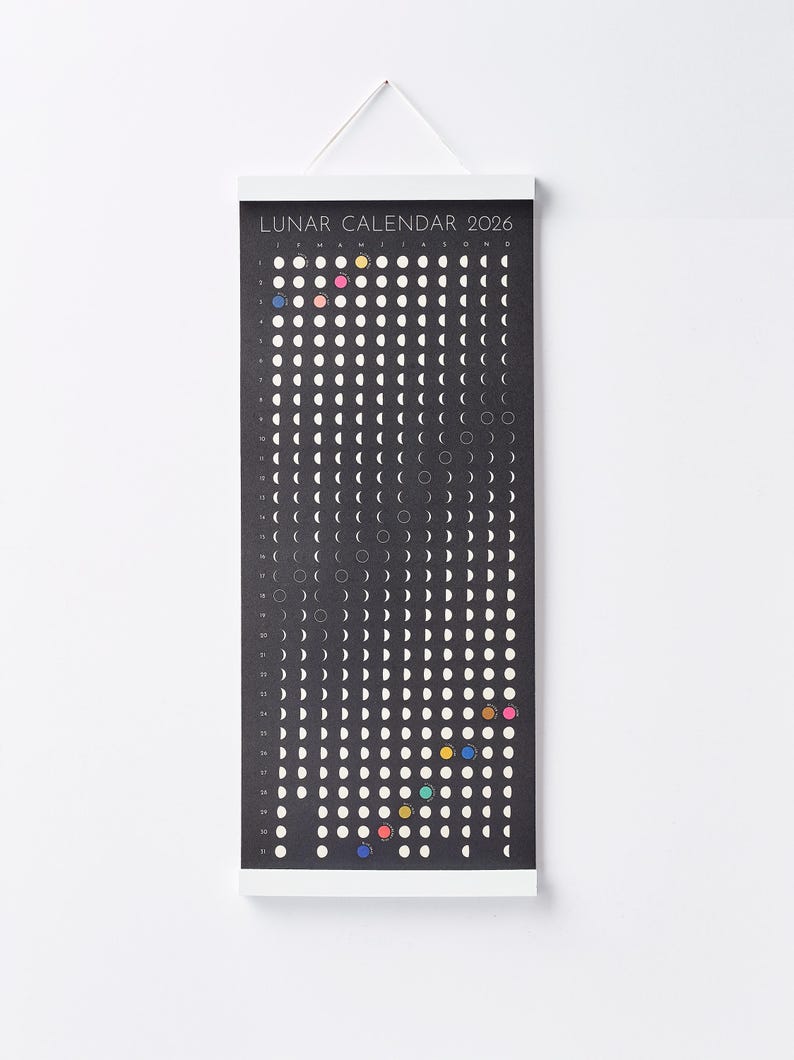 Moon Phase Lunar Calendar Print  hanging on wall with white magnetic poster frame, modern minimalist home décor.