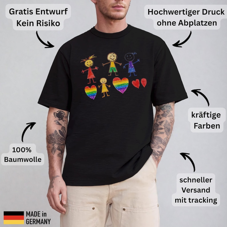 May include: Black t-shirt with a colorful crayon drawing of stick figures and rainbow hearts. The shirt is made of 100% cotton and features the text "MADE IN GERMANY".