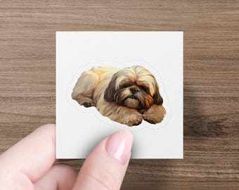 May include: A sticker featuring a brown and white Shih Tzu dog lying down with its head resting on its paws.