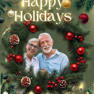 May include: A festive holiday card featuring a portrait of an older couple with gray hair, framed by a lush green pine wreath decorated with red ornaments, pinecones, and berries. The text Happy Holidays is centered in white above the couple.