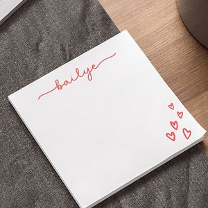May include: White notepad with the name "bailye" written in red cursive. The notepad has a red heart design on the right side.