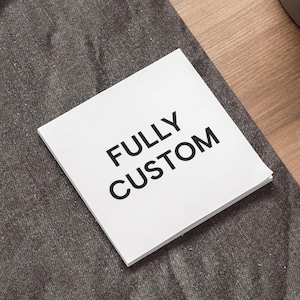 May include: White card with the text "FULLY CUSTOM" in black lettering.
