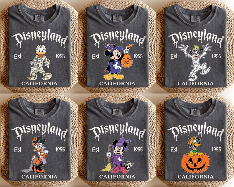 May include: Six dark gray t-shirts with Halloween-themed Disneyland graphics. Each shirt features a different Disney character dressed in a Halloween costume, with the Disneyland logo and "Est 1955 California" printed on the front.