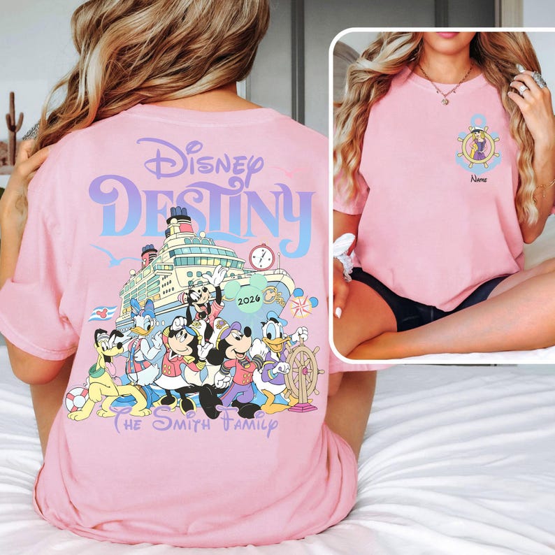 May include: Pink t-shirt featuring the words "Disney Destiny" above a graphic of a cruise ship with Disney characters. The shirt also includes the text "The Smith Family" and the year "2026". A smaller image on the right shows a similar shirt.