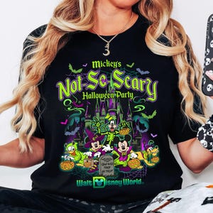 May include: Black t-shirt with a Halloween-themed graphic featuring Disney characters. The design includes the text "Mickey's Not-So-Scary Halloween Party" and "Walt Disney World."