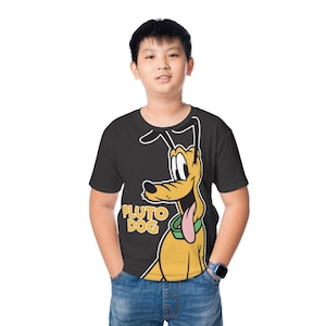 May include: A black t-shirt featuring a cartoon image of Pluto the Dog. The yellow Pluto character has a pink tongue and a green collar. The words "PLUTO DOG" are printed in yellow. The person is wearing blue jeans.