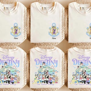May include: Cream-colored t-shirts with Disney-themed graphics. Some shirts feature an anchor design with a cartoon character and the name "Name". Other shirts display "Disney Destiny" with a cruise ship and cartoon characters. The Smith Family is also printed on the shirts.