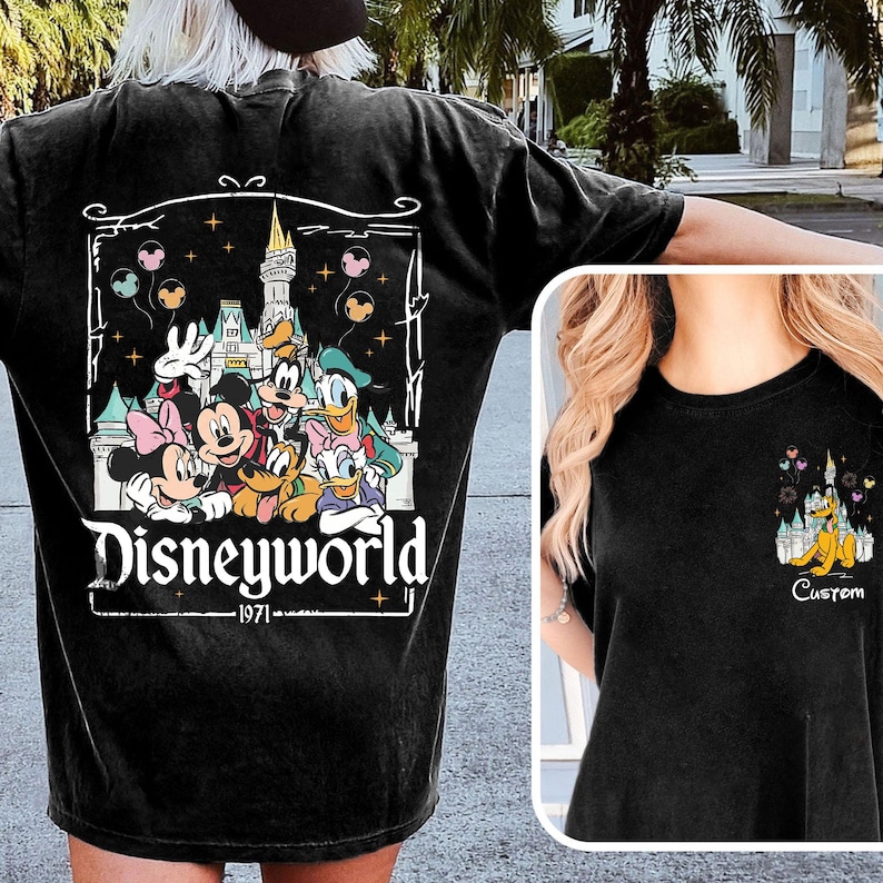 May include: Black t-shirt with a Disney World graphic featuring Mickey, Minnie, Donald, and Goofy. The design includes a castle, balloons, and the text "Disneyworld - 1971". A smaller version of the graphic is on the front.