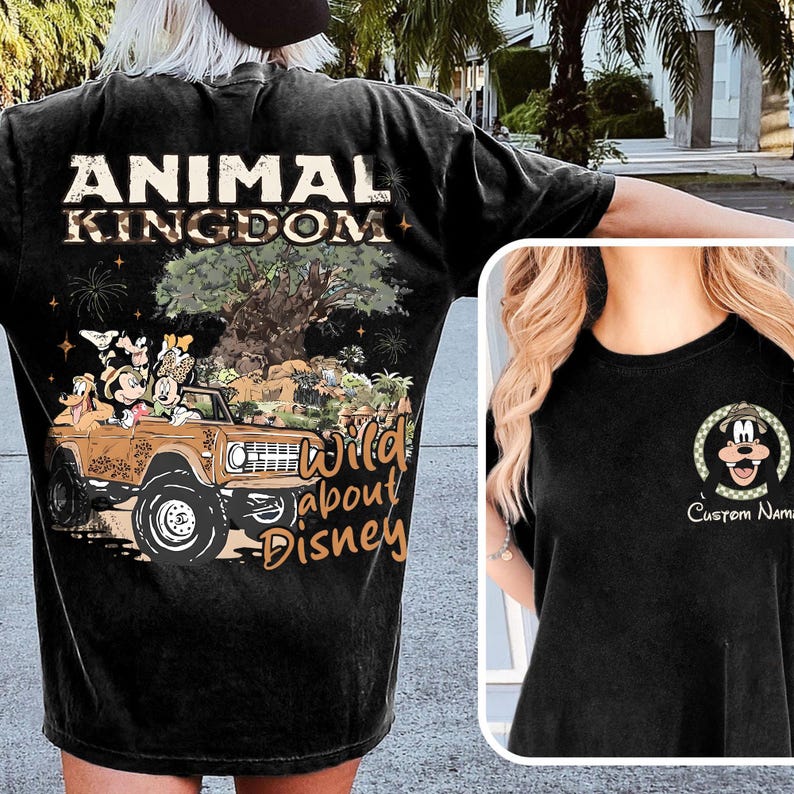 May include: Black t-shirt featuring a graphic of Mickey Mouse and friends in a brown jeep with the text "Animal Kingdom" and "Wild About Disney". A smaller image of Mickey Mouse is on the front.