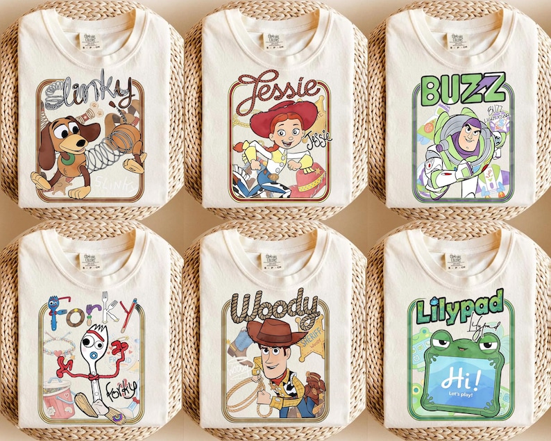 May include: Six off-white t-shirts featuring graphic prints of characters including Slinky, Jessie, Buzz Lightyear, Forky, Woody, and a frog labelled Lilypad. Each shirt displays a rectangular frame with character names and illustrations.