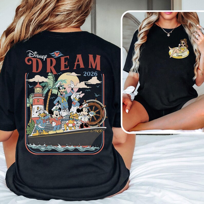 May include: Black t-shirt with a Disney Dream cruise design. The back graphic shows Mickey Mouse, Donald Duck, Goofy, and other characters on a ship, with a lighthouse and the year 2026. The front has a small graphic of a character.