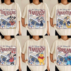May include: Cream-colored t-shirts featuring Disney characters and cruise ship designs. Each shirt has a different theme: Treasure, Fantasy, Adventure, and Dream. The text "Disney 2026" and "Name" are also printed on the shirts.