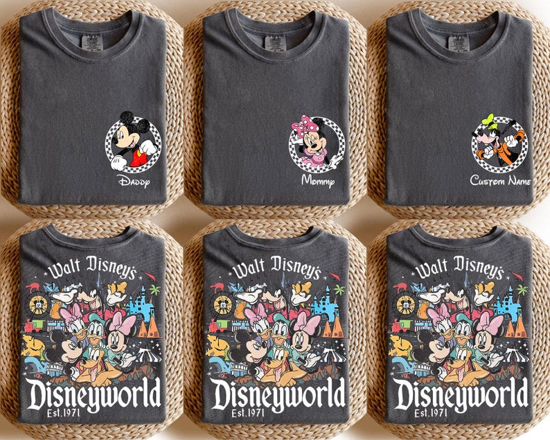 May include: Six dark gray t-shirts. Three shirts have Disney character graphics with the words "Daddy", "Mommy", and "Custom Name". The other three shirts have a colorful Disney World graphic with the words "Walt Disney's Disneyworld Est. 1971".