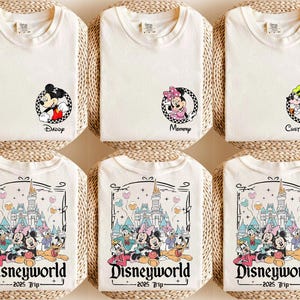 May include: Set of three white t-shirts with different Disney character designs. The shirts feature Mickey Mouse, Minnie Mouse, and Pluto. Each shirt has a different text: "Daddy", "Mommy", and "Custom Name". The shirts also feature a Disney World logo with the text "Disneyworld - 2025 Trip - ".