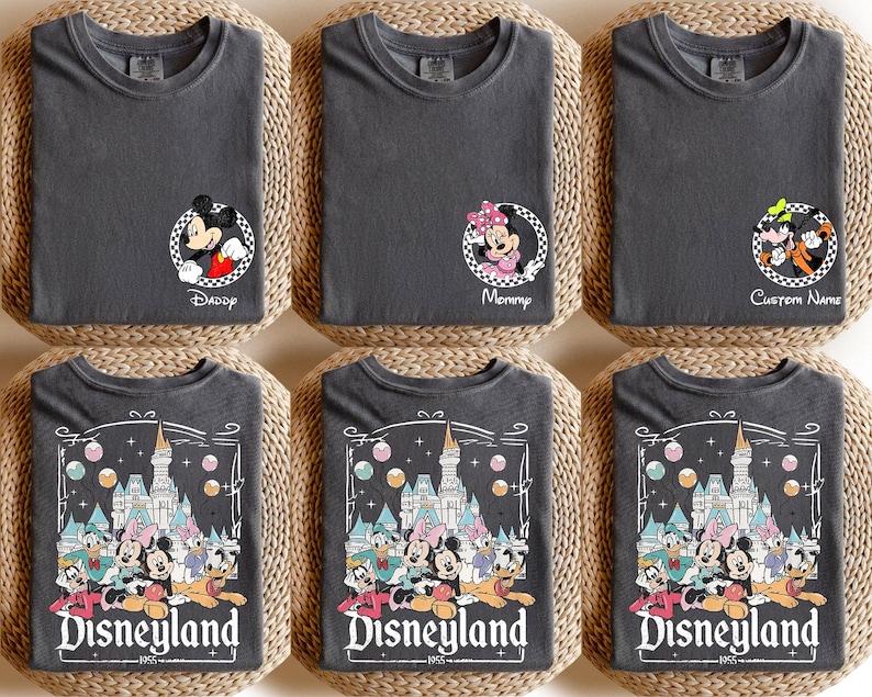 May include: Set of six gray t-shirts featuring Disney characters and the text "Disneyland" with a castle graphic. The shirts are designed for a family with a "Daddy", "Mommy", and four children.