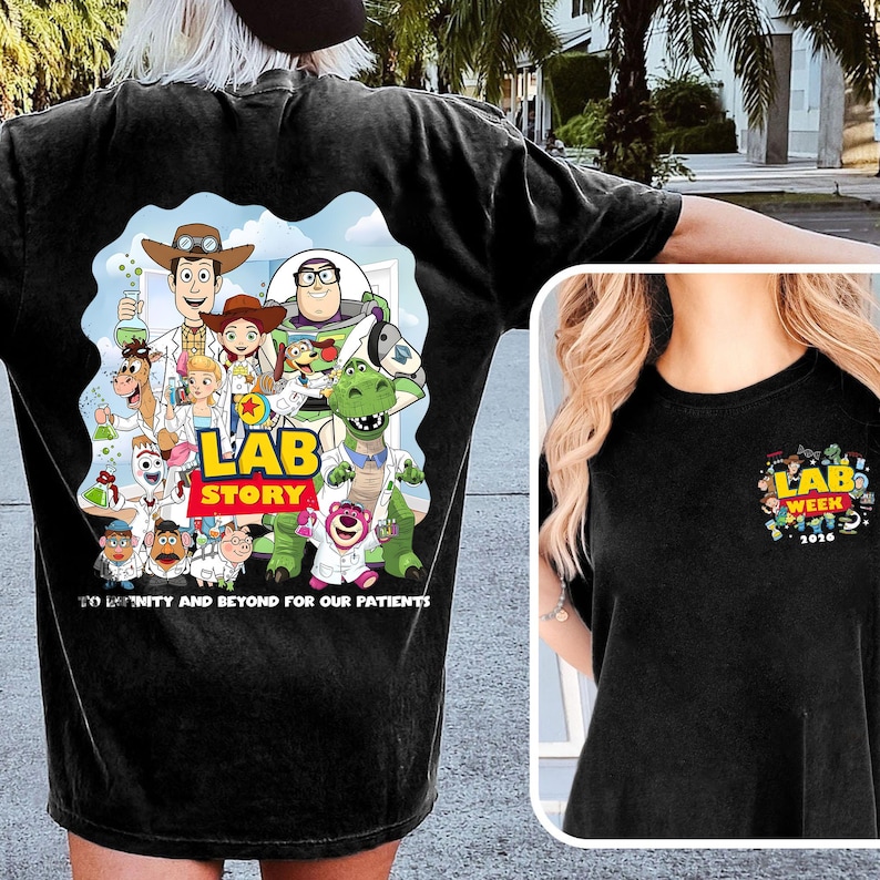 May include: Black t-shirt featuring a colorful graphic of cartoon characters with the text "LAB STORY" and "TO INFINITY AND BEYOND FOR OUR PATIENTS". A smaller graphic on the chest reads "LAB WEEK 2020".