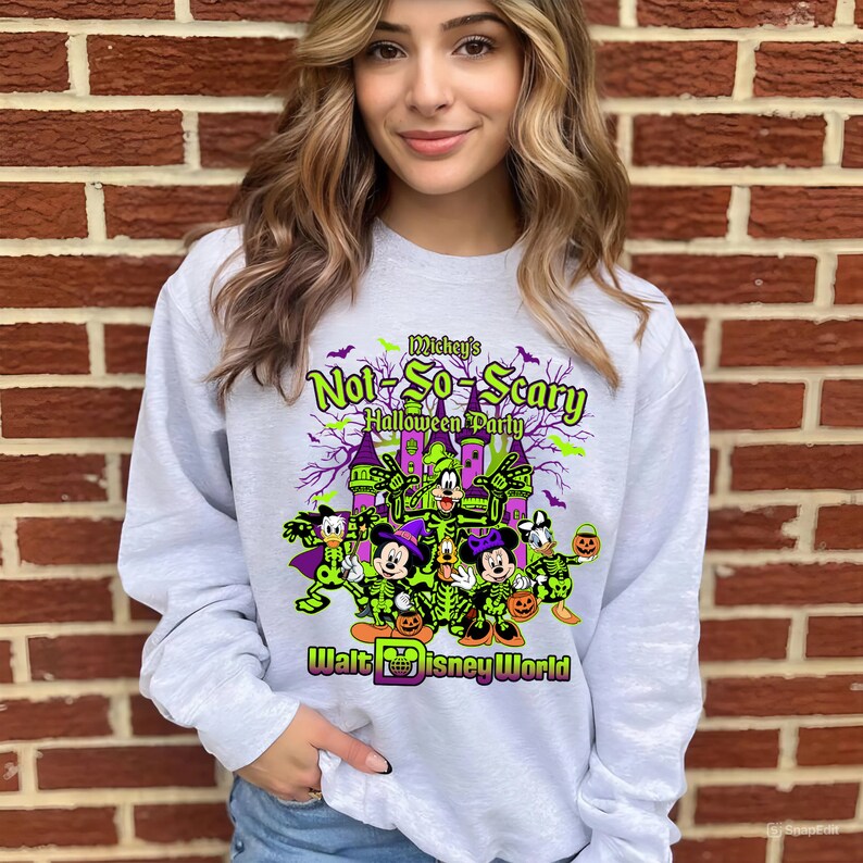 May include: A light gray sweatshirt featuring a Halloween-themed graphic. The design includes the text "Mickey's Not-So-Scary Halloween Party" with Disney characters in costume, and the words "Walt Disney World".