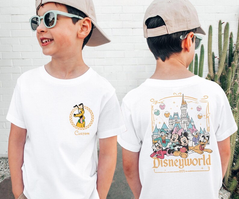 May include: White t-shirt with a cartoon image of Pluto on the front and a graphic of Mickey Mouse and friends in front of Cinderella's Castle on the back. The back graphic also includes the text "Disneyworld - 1971 - ".