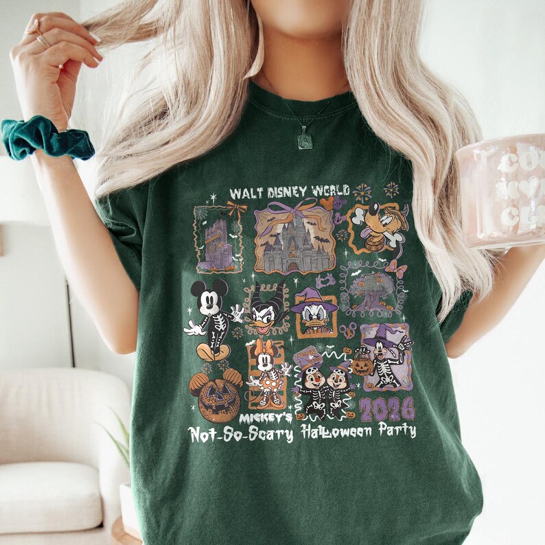 May include: Dark green t-shirt featuring a graphic design for Mickey's Not-So-Scary Halloween Party 2026 at Walt Disney World. The design includes images of Mickey Mouse, Donald Duck, and other Disney characters in Halloween costumes.