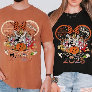 May include: Two t-shirts, one terracotta and one black, with a Halloween design. The graphic includes Mickey Mouse, Minnie Mouse, Donald Duck, and Goofy, a pumpkin, and the text "NOT SO SCARY HALLOWEEN PARTY!" and "2023".