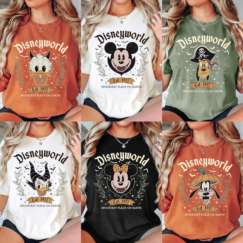 May include: Collection of six t-shirts with the text "Disneyworld" and various character designs. Each shirt features a different color, including orange, white, black, and green. The shirts have the text "Est. 1971" and "Spookiest Place on Earth".