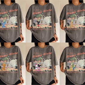 May include: A collection of six gray t-shirts featuring a vintage-style graphic of Disney World in Florida. Each shirt showcases a different Disney character, including Stitch, Mickey Mouse, and Goofy, with the text "Florida Disney World".