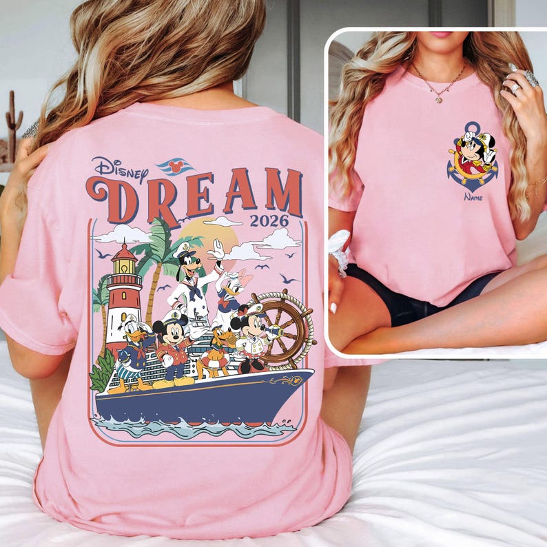 May include: Pink t-shirt featuring a Disney Dream cruise design. The back graphic includes Disney characters on a ship with a lighthouse and the text "DREAM 2026." The front has an anchor design with Mickey Mouse and the text "Name."