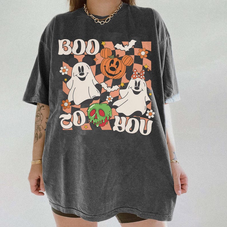 May include: Dark gray t-shirt with a Halloween-themed graphic. The design features the text "BOO TO YOU" with cartoon ghosts, a pumpkin with Mickey Mouse ears, and a green skull apple on a checkered background.