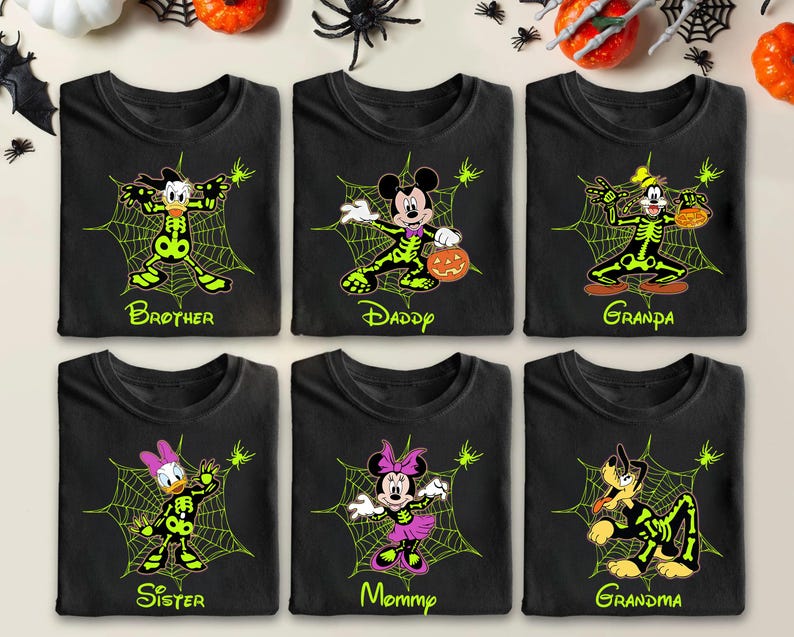 May include: Six black t-shirts with Halloween-themed designs. Each shirt features a different Disney character in a skeleton costume, surrounded by a spider web. The shirts are labeled "Brother", "Daddy", "Grandpa", "Sister", "Mommy", and "Grandma".