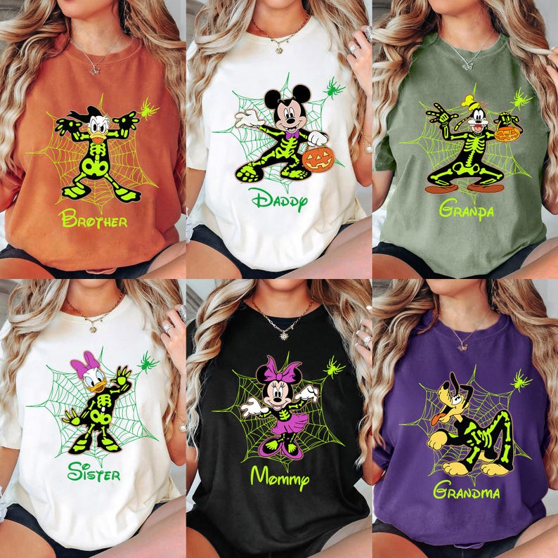May include: A collection of Halloween-themed t-shirts featuring Disney characters in skeleton costumes. Each shirt has a different character, including Donald Duck, Mickey Mouse, Goofy, Daisy Duck, Minnie Mouse, and Pluto, with text like "Brother" and "Mommy".