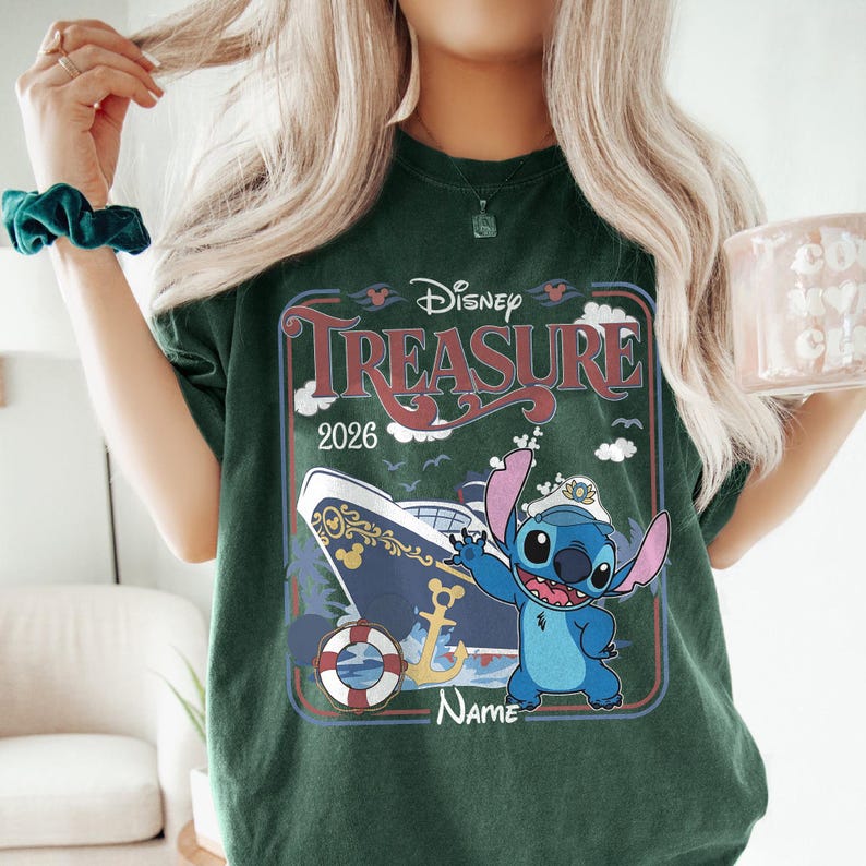 May include: Dark green t-shirt featuring a Disney Treasure cruise design. The graphic includes a cruise ship, the character Stitch, and the text "Disney Treasure 2026". The design is framed in a retro style.