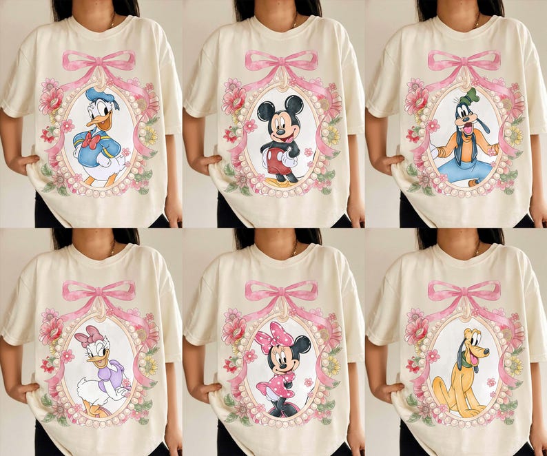 May include: Cream-colored t-shirts featuring Disney characters: Donald Duck, Mickey Mouse, Goofy, Daisy Duck, Minnie Mouse, and Pluto. Each character is framed in an oval with a pink bow and floral accents. The shirts have short sleeves.