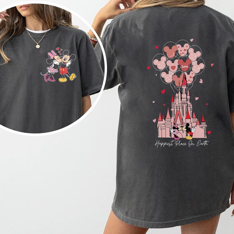 May include: Dark gray t-shirt featuring Mickey and Minnie Mouse. The front shows the couple embracing, while the back displays a castle with Mickey and Minnie, balloons, and the text "Happiest Place On Earth."