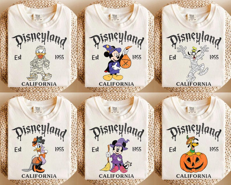 May include: Six off-white t-shirts with Disneyland graphics. Each shirt features a different cartoon character dressed in Halloween costumes. The Disneyland logo is in a spooky font, with "Est 1955 CALIFORNIA" below.
