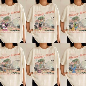 May include: A white ceramic mug with a black handle and the text "But First, Coffee" in a bold, black font. The mug is set against a blurred background, suggesting a cozy setting.