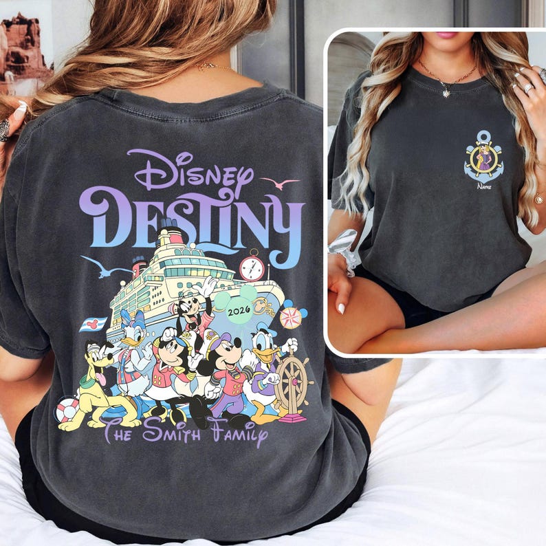 May include: Dark gray t-shirt featuring the words "Disney Destiny" in purple and blue, with a cruise ship graphic and Disney characters. The shirt also includes "The Smith Family" text.