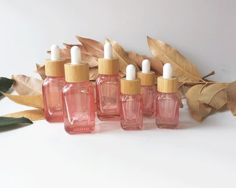 Botella cuentagotas de vidrio rojo rosa de 15 ml y 35 ml con tapa de bambú, botella de aceite esencial vacía con pajita de vidrio puro, contenedor de muestra de viaje de maquillaje