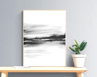 May include: Black and white abstract watercolor painting with a horizontal line in the middle. The painting is framed in a light wood frame and is hanging on a gray wall.