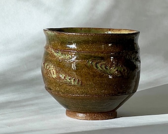 Textured green wheel thrown stoneware ceramic pottery tea and coffee cup.